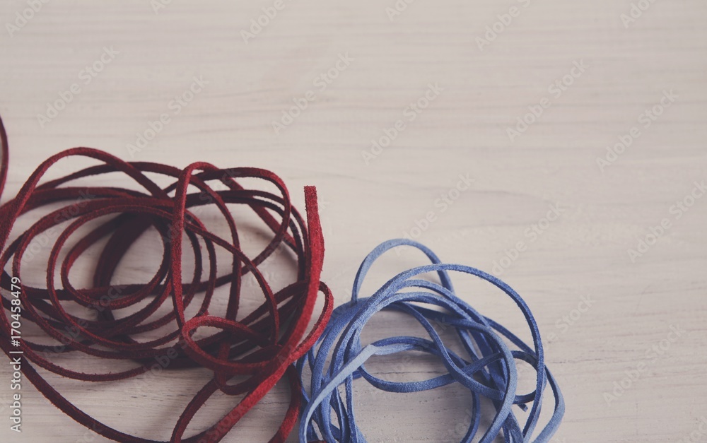 Red and blue braid on white table copy space Red and blue braid on white table copy space