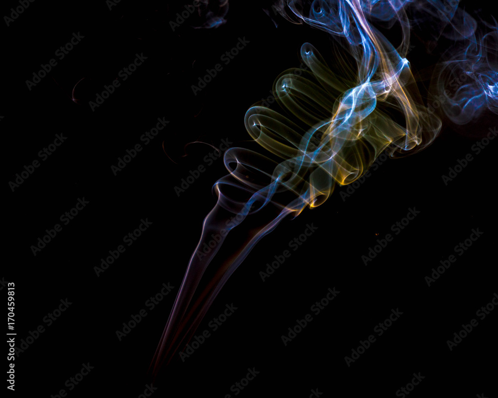 multicolored smoke dissipates in the air on an isolated black background multicolored smoke dissipates in the air on an isolated black background