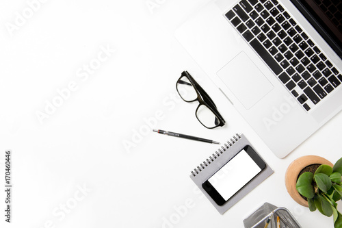 office desk table top header layout to right glasses pen smart phone mobile on top notebook grey add up plant in flowerpot