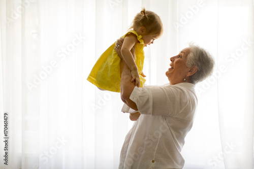 Grandmother holding little granddaughter