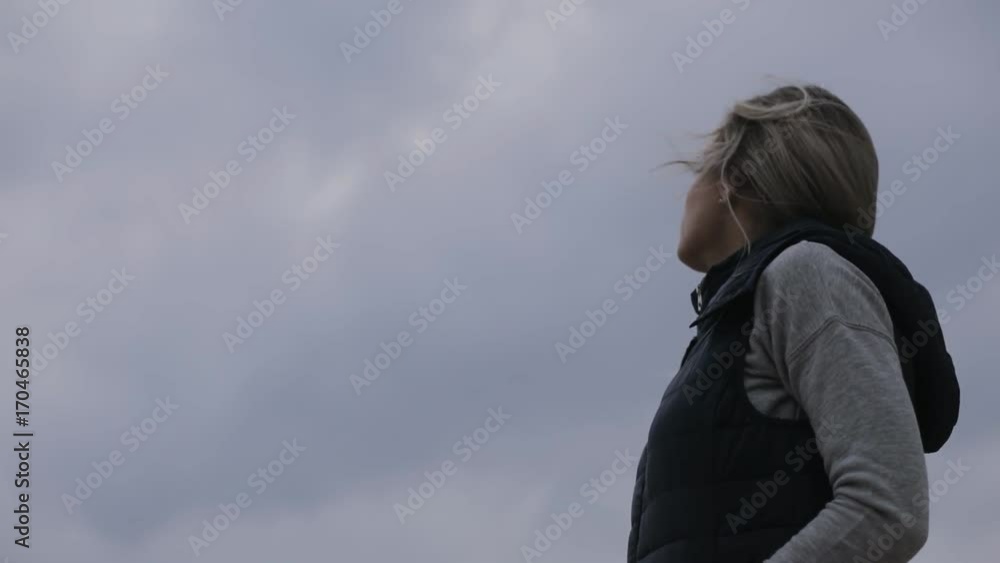 Cloudy, cold autumn day. Woman waiting her friend. Fresh air winds outdoor. Cloudy, cold autumn day. Woman waiting her friend. Fresh air winds outdoor.