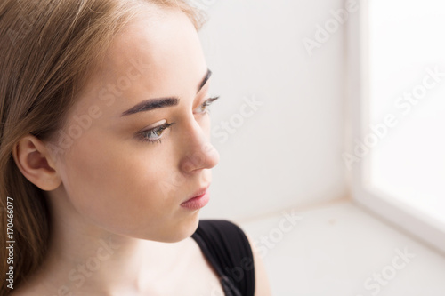 Portrait of a sad young girl on white background