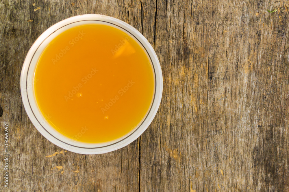 Sweet honey in bowl on rustic wooden table Sweet honey in bowl on rustic wooden table