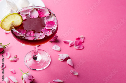 Rose cocktail in champagne glass on pink background © Prostock-studio