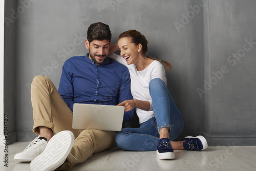 Shopping on the internet. Shot of a lovely young couple using laptop and browsing together on the internet.  © gzorgz