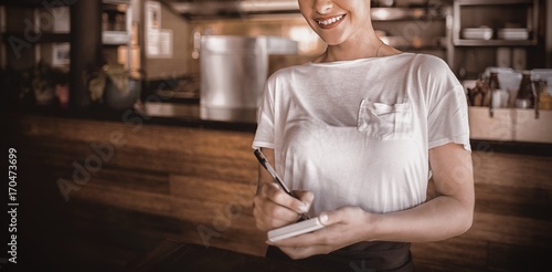 Smiling waitress standing in restaurant