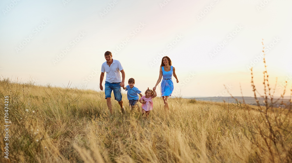 Happy family playing on nature in autumn summer.