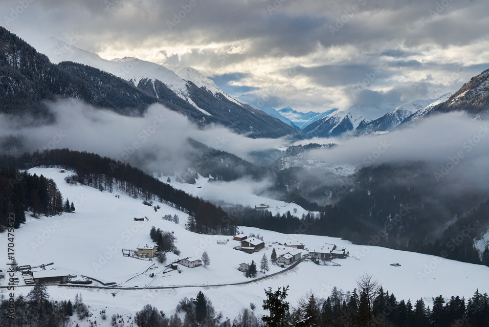 Winter mountain misty and cloudy valley view from Castle of Tarasp landmark of the Lower Engadine, in the Switzerland.