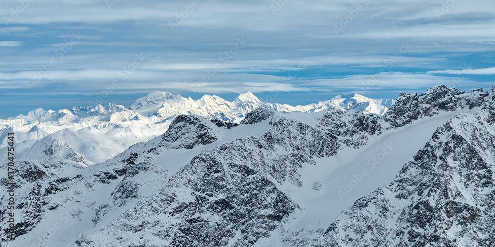 Obraz premium Winter snowy mountain panoramic view from Corvatsch peak of the Lower Engadine, in the Switzerland.