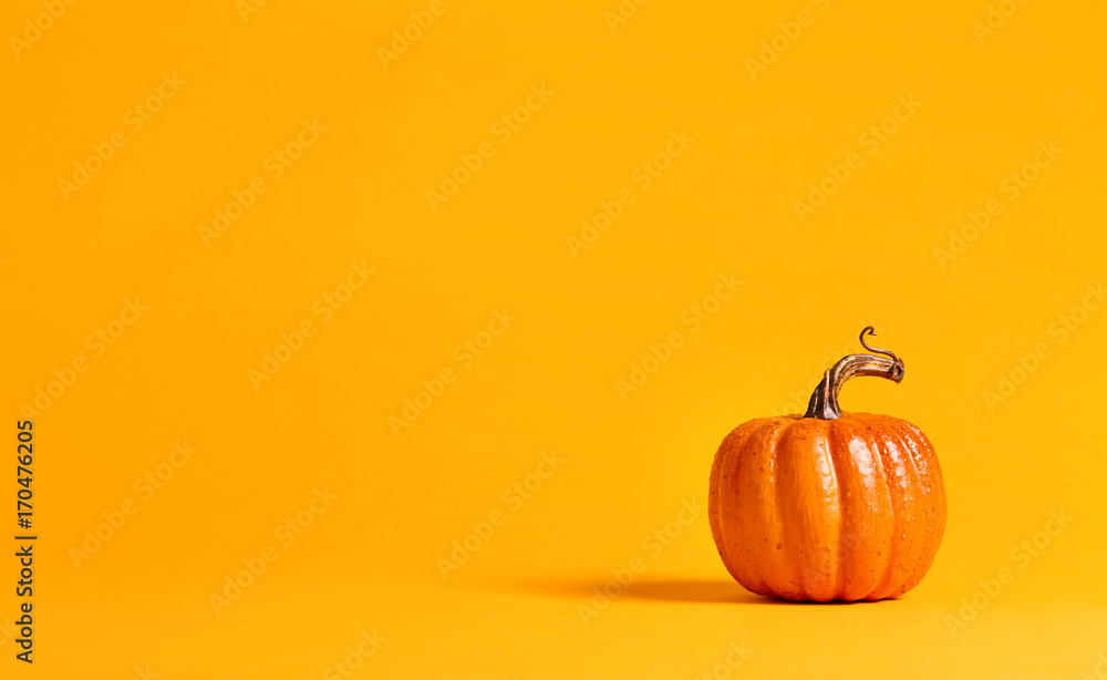 Halloween pumpkin decorations on a yellow-orange background - obrazy, fototapety, plakaty 