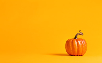 Halloween pumpkin decorations on a yellow-orange background
