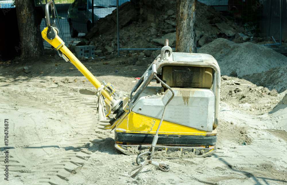 Compactor machinery at street reconstruction site