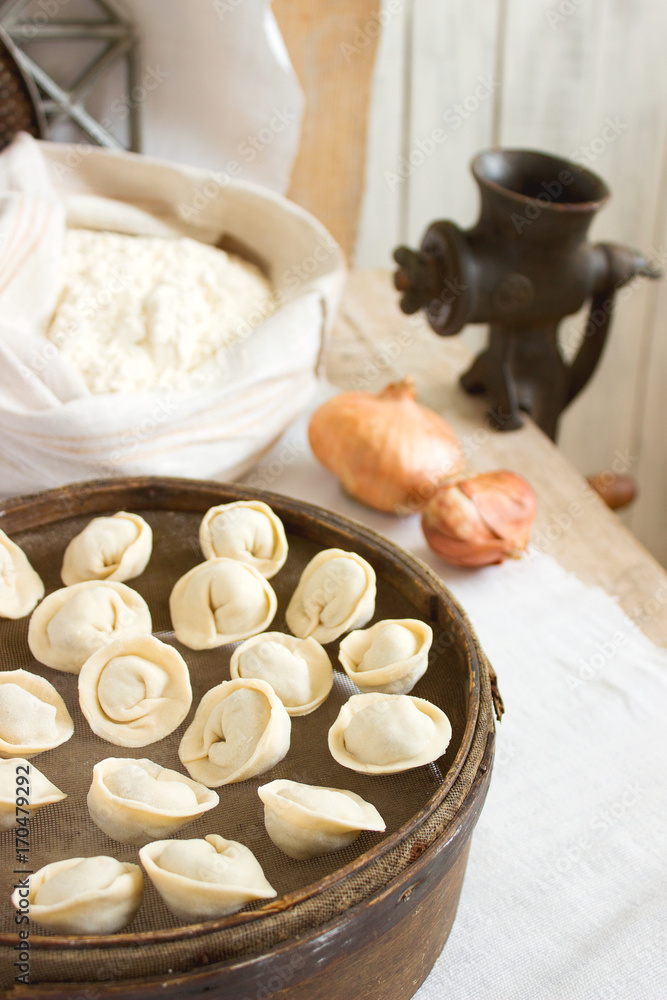 Traditional pelmeni or dumpling at cutting board. Homemade preparation food. Traditional pelmeni or dumpling at cutting board. Homemade preparation food.