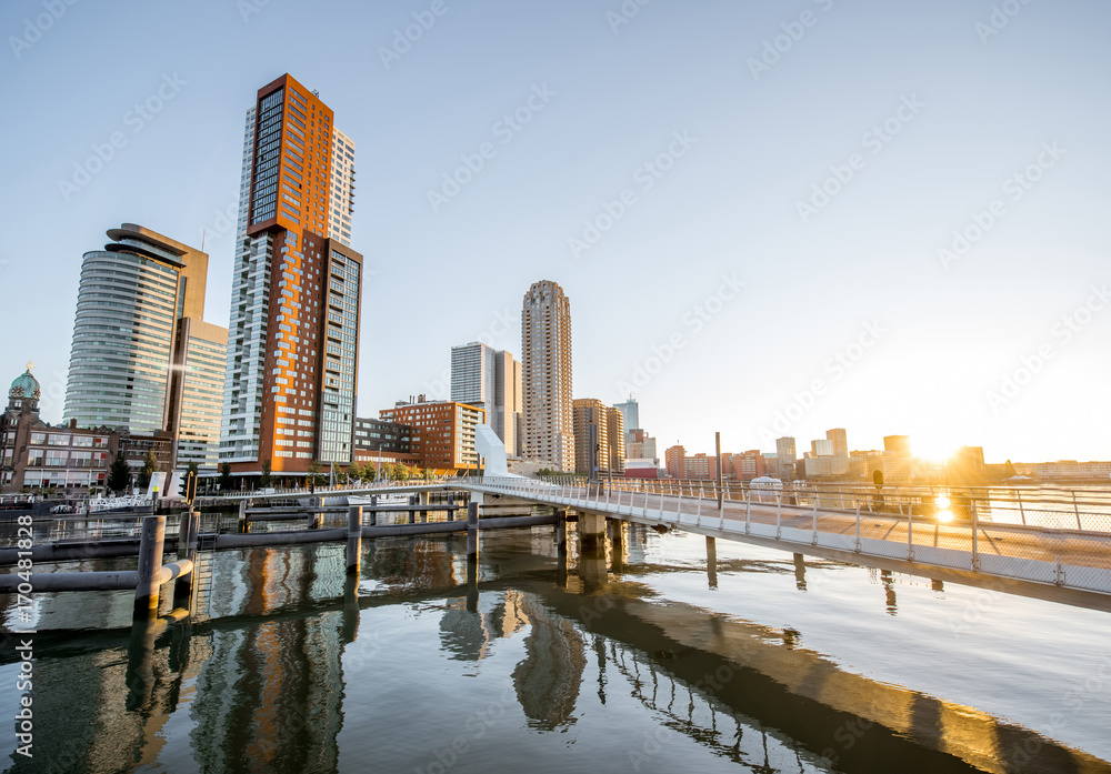 Obraz premium Cityscape view on the modern district with beautiful skyscrapers at the Rijn port during the morning in Rotterdam