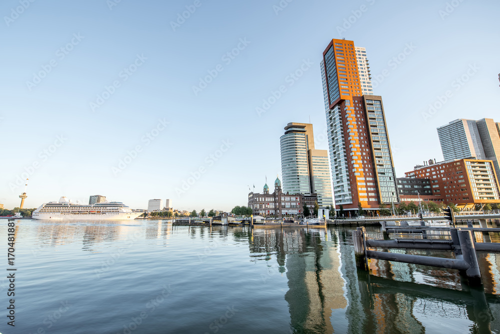 Obraz premium Cityscape view on the modern district with beautiful skyscrapers at the Rijn port during the morning in Rotterdam