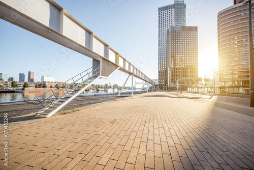 Cityscape view with the modern footbridge and skyscrapers during the morning in Rotterdam