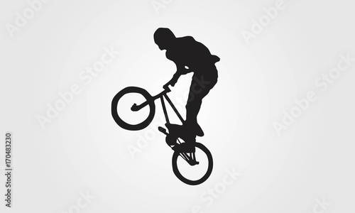 Fototapeta Naklejka Na Ścianę i Meble -  Cyclist rider bmx performs trick jump logo silhouette vector