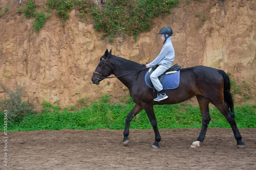 teen learning to ride a horse