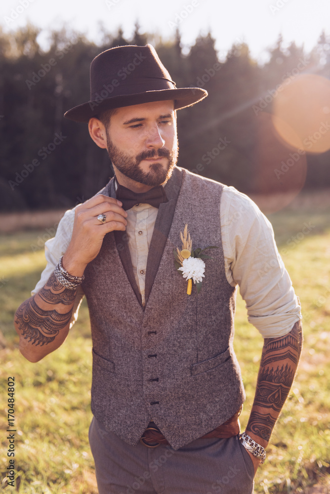 Obraz premium Portrait of stylish beard, male with tattoos on his arms. Wedding portrait