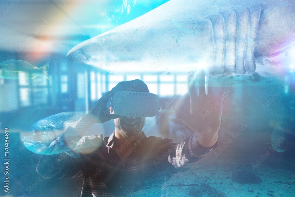 Fotografie Composite image of smiling man using virtual reality glasses