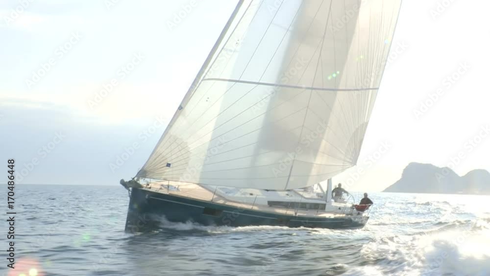 Sailing boat navigating fast in the sea with open sails. Sailing boat navigating fast in the sea with open sails.
