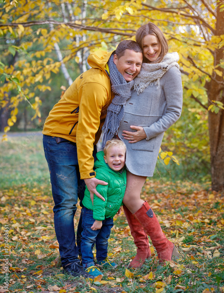 Happy family playing in autumn park Happy family playing in autumn park