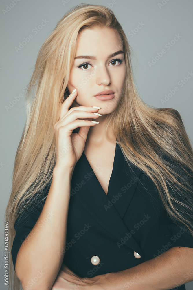 Beauty Woman face Portrait. Beautiful model . Blonde female looking at camera and smiling on gray background. Beauty Woman face Portrait. Beautiful model . Blonde female looking at camera and smiling on gray background.