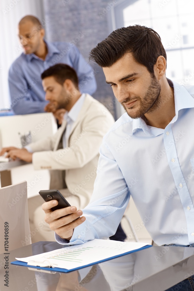 Handsome businessman using mobilephone Handsome businessman using mobilephone
