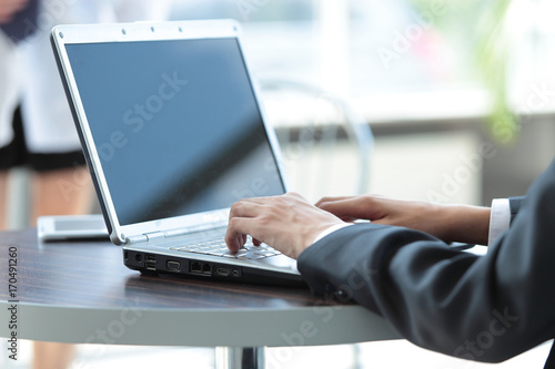 Picture of hands of business man working on laptop.
