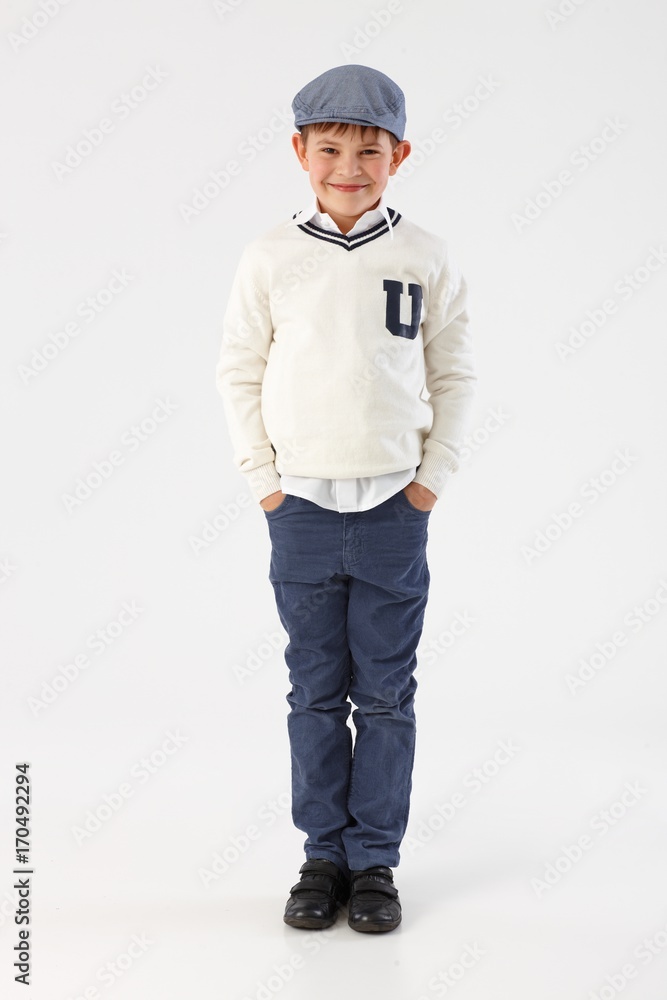 Happy little boy standing with hands in pockets Happy little boy standing with hands in pockets