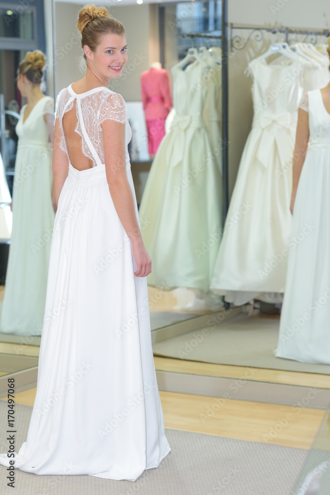 Naklejka premium women choosing wedding dress in shop