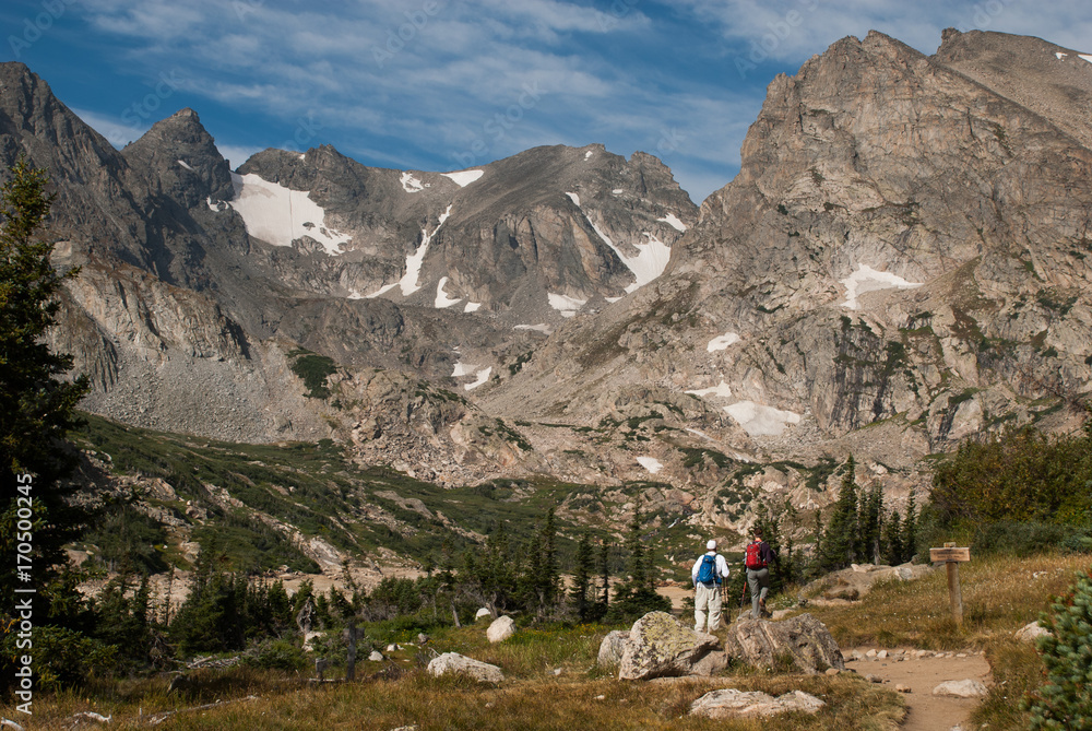 Two athletic hikers climb a mountain in the high altitude of Colorado