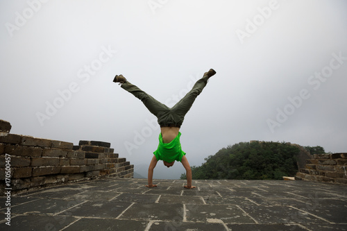 Photography handstand young woman on top of great wall