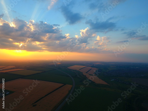 Aerial view of beautiful village, houses, roads. Sky, clouds, sunset. © PhotoStocker