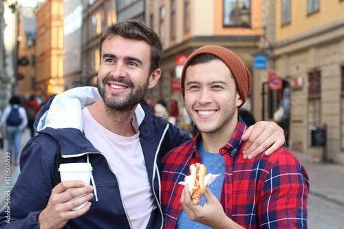 Beautiful homosexual couple strolling the city streets