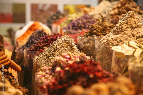 Spices piled high in a spice market - scene in Dubai Sprice Souk, UAE - United Arab Emirates photo