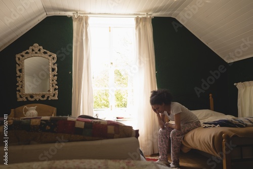 Stressed woman sitting in the bedroom photo