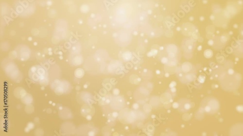 Christmas animated bokeh background with glowing light particle floating against golden backdrop.