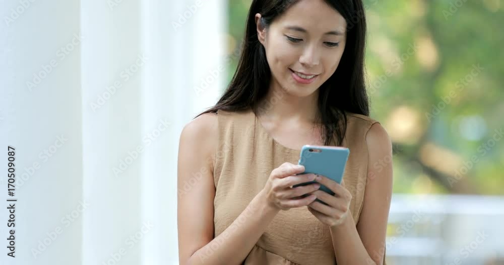 Student walking in the campus and using smart phone Student walking in the campus and using smart phone