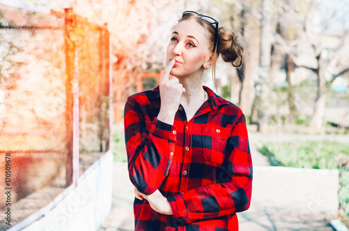 the girl thoughtful. turned her head to the side. stands on the street photo