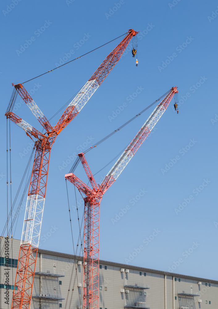 Close - up big red crane at construction site Close - up big red crane at construction site