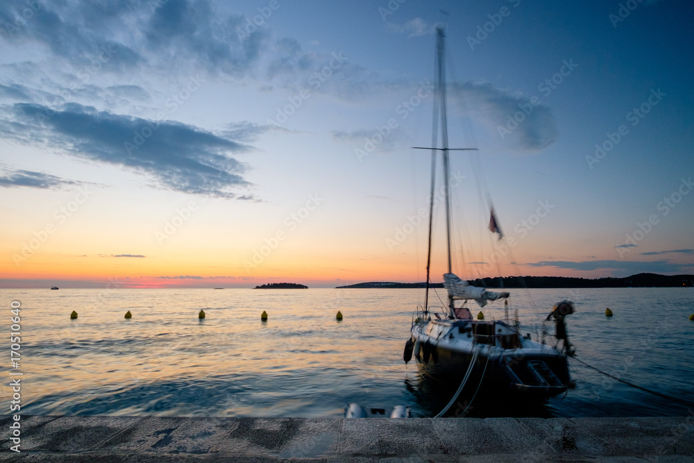 Boats rock themselves to sleep at sunset in Rovinj Croatia
