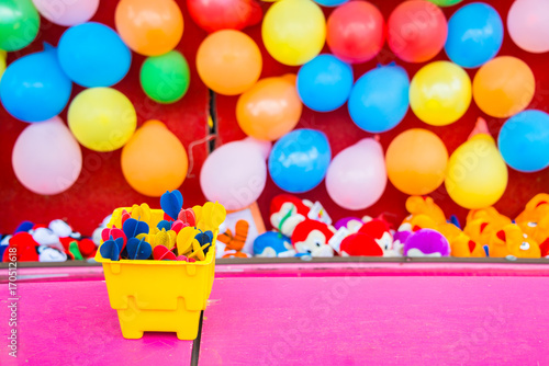 Colorful Darts, Balloons, and Stuffed Animal Prizes in an Amusement Park
