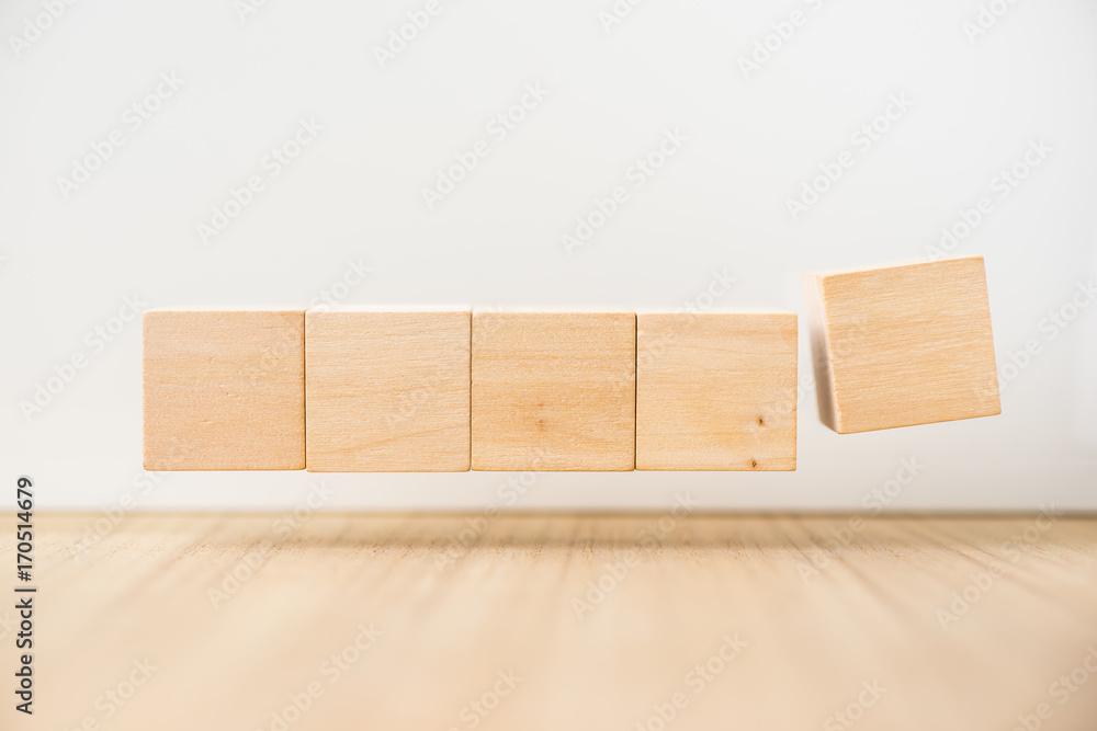 Business concept - Abstract geometric real floating wooden cube on grey background and it's not 3D render, float on wood floor white background for display or montage word. Business concept - Abstract geometric real floating wooden cube on grey background and it's not 3D render, float on wood floor white background for display or montage word.