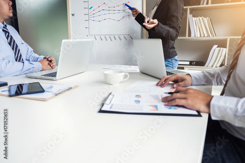 Business people are working in office, presentation in front of Whiteboard, business woman leader presentation to her colleagues and business strategy and pointing to the board