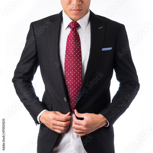 Asia business concept - thoughtful modern office man with dark suit looking down, stand and think the business plan, isolated on white background.