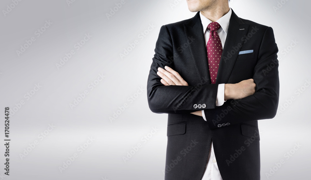 Business concept - confident modern business man with dark suit , stand and think the business plan, isolated on grey background. Business concept - confident modern business man with dark suit , stand and think the business plan, isolated on grey background.