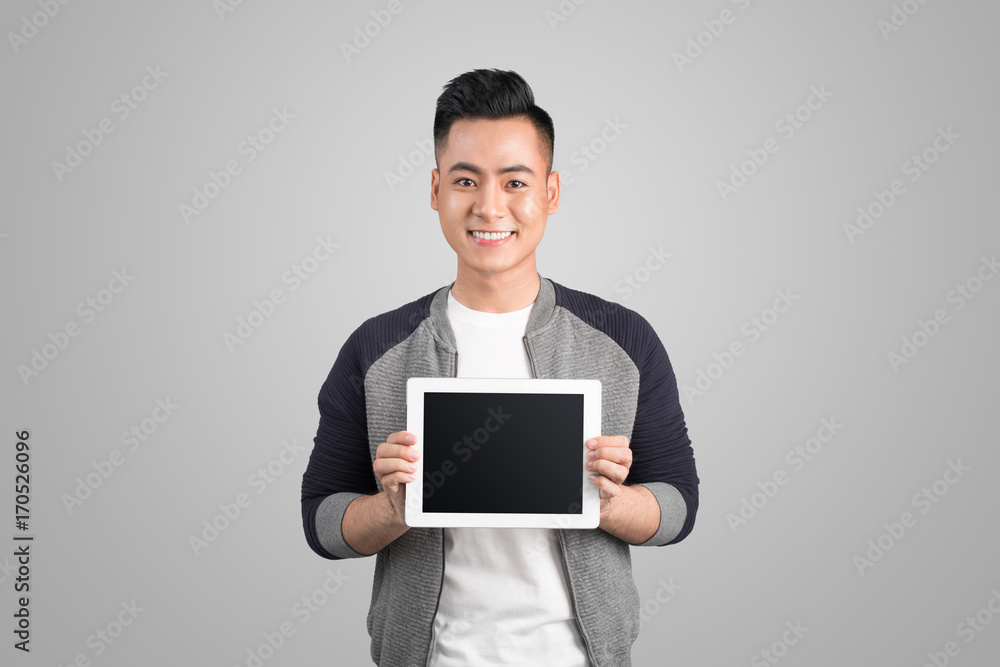 Confident young asian businessman showing screen of digital tablet