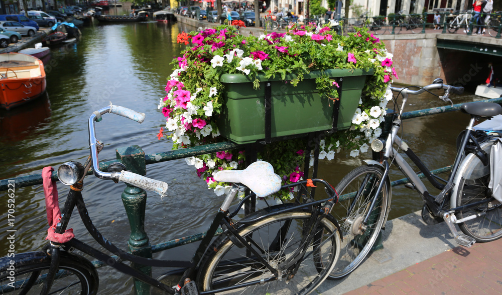 bicycles over to the bridge in the city of Amsterdam in Holland