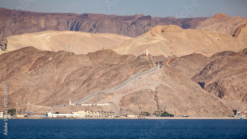 Coastline landscape of the boarder between Egypt and Israel on the Red Sea in the Gulf of Aqaba. The fence is the boarderline. / Egypt and Israel Coastal Landscape